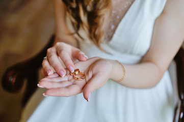 bride's wedding bands in the palm of his hand