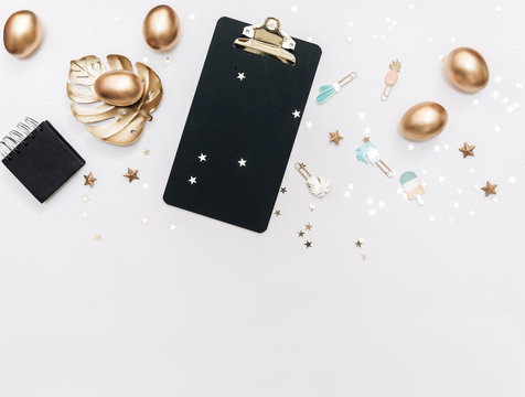 Flat lay Gold Easter eggs with decorations on white background. top view, Minimal Easter holiday concept