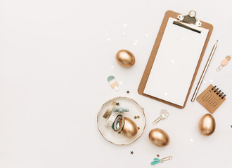 Happy Easter! Stylish stationery background with gold eggs on white background. Minimal concept.Table decorating for holiday. Feminine flat lay. Blog easter concept.