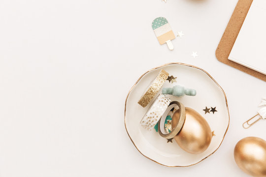 Happy Easter! Stylish stationery background with gold eggs on white background. Minimal concept.Table decorating for holiday. Feminine flat lay. Blog easter concept.