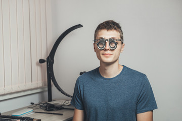 Male patient to wear glasses for vision correction. Hospital, medical examination.