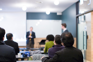 Speaker at Talk in Business Conference. Executive Speaker Entrepreneur on Stage Conference Photo. Business Presentation Presenter Speech at Tech Meeting. Corporate Forum Event for Investor Audience.