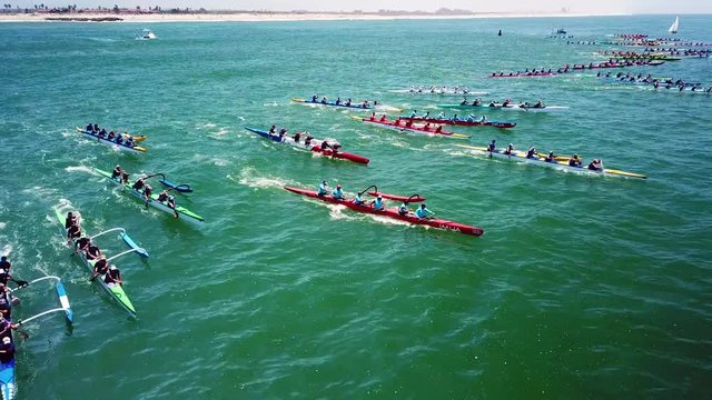 Aerial over outrigger canoes racing in a rowing race on the Pacific ocean near Ventura, California.