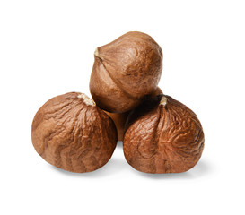 A small pile of peeled hazelnuts on a white isolated background. Side view. Close-up. Macro.