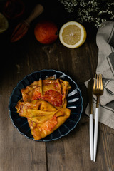 Traditional french crepes suzette with red bloody oranges, russian blini pancakes - Shrovetide maslenitsa festival meal