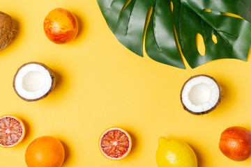 Tropical fruits, blood oranges, coconut, lemon, monstera leaf
