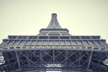 View of the Eiffel tower on a clear blue sky day. view from below the tower. black and white.
