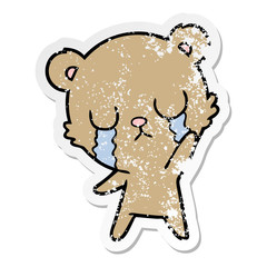 distressed sticker of a crying cartoon bear waving