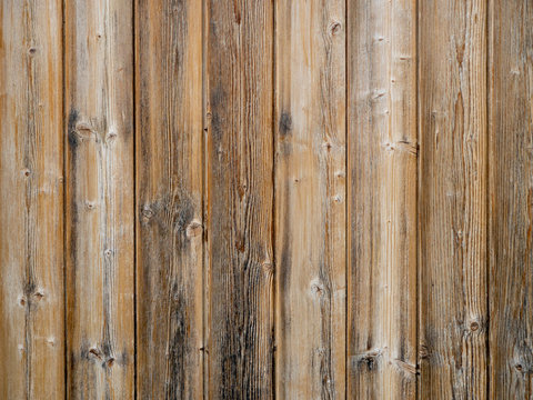 Wood slats background,old exterior cladding with vertical planks. © Mushy