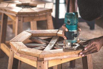 close up carpenter working with hand tool 