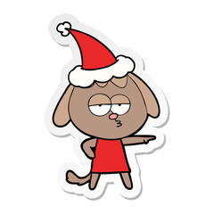 sticker cartoon of a bored dog wearing santa hat