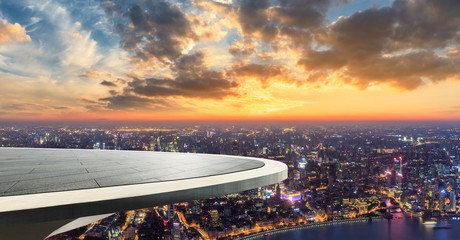 Empty floor platform and modern city skyline with buildings in Shanghai at night