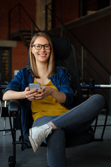 Portrait of a girl with a phone in a modern office