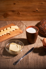 Assorted dairy products milk, cheese, butter rustic still life on table