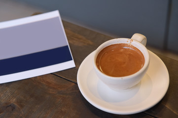 a cup of latte art coffee on wooden background