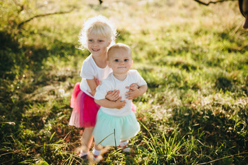 two little sisters having fun, laughing, smiling