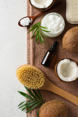 Fototapeta na wymiar Dry massage brush with coconuts oil, health wellness concept with accessories on white background