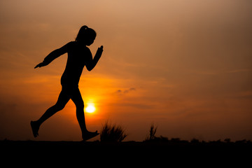 young fitness woman running on sunset seaside trail - Image