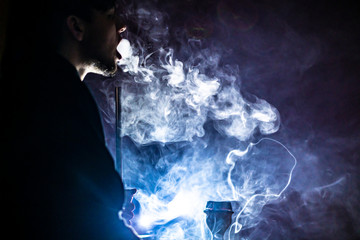 person smoke hookah in dark place b