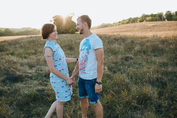 Young beautiful couple walking outside on beautiful sunset