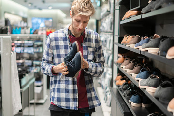 man choose new shoes in the store b