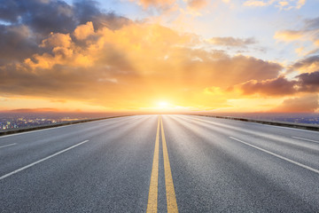 Naklejka premium Asphalt road through the modern city above in Shanghai at sunset