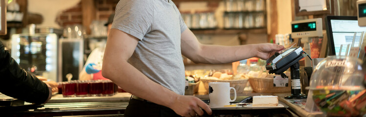 person paying for order with credit card in cafe b