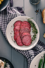 Salami slices served with herbs