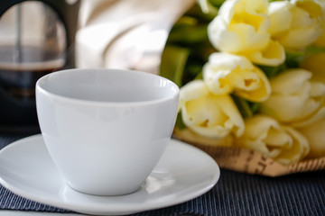 Coffee cup and bouquet of