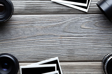 Old lenses and photo frames on wooden table