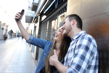 Couple taking selfie with smart phone in the street