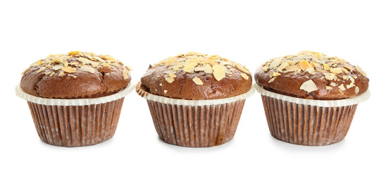 Tasty almond muffins on white background