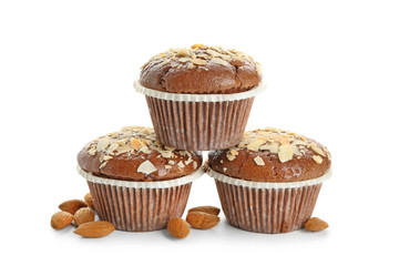 Tasty almond muffins on white background