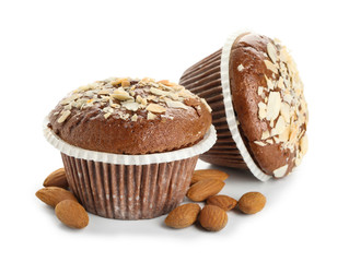 Tasty almond muffins on white background