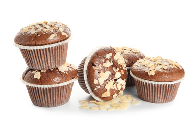 Tasty almond muffins on white background