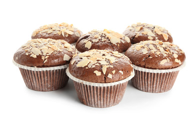 Tasty almond muffins on white background