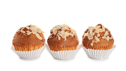 Tasty almond muffins on white background