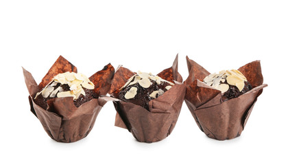 Tasty almond muffins on white background