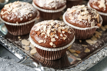 Tasty almond muffins on tray, closeup