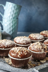 Tray with tasty almond muffins on table