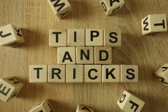 Tips and tricks text from wooden blocks on desk