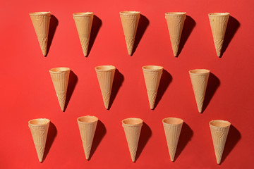 Delicious waffle cones on color background