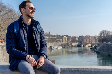 Rome/Italy 21 february 2019 :snapshot of a man is sitting in the bridge looks happy and enjoy the nice weather