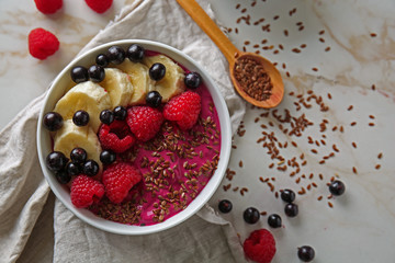 Bowl with tasty acai smoothie on light table