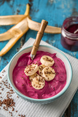 Bowl with tasty acai smoothie on table