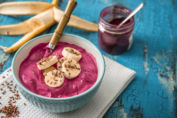 Bowl with tasty acai smoothie on table