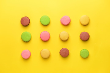 Tasty macarons on color background