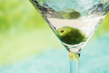 Martini cocktail with green olive