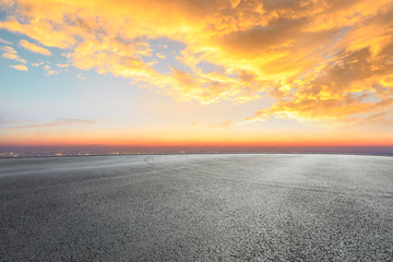 Empty asphalt square ground and city skyline with beautiful clouds at sunset