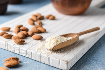 Scoop with tasty almond flour on table